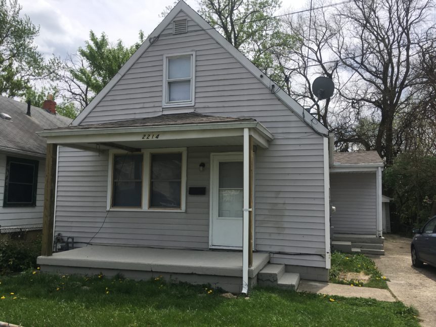 Gray house with awning over window and door