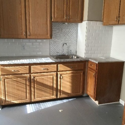 Renovated kitchen with light wood cabinetes